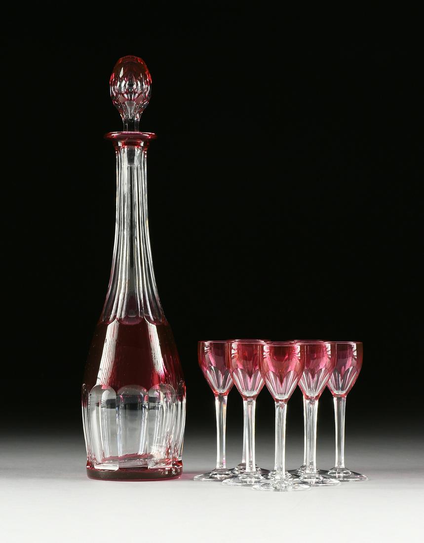A NINE PIECE FRENCH CRANBERRY CUT TO CLEAR CRYSTAL: A NINE PIECE FRENCH CRANBERRY CUT TO CLEAR CRYSTAL LIQUEUR SET, VAL ST LAMBERT, BACCARAT, MARKED, 20TH CENTURY, comprising a Val St Lambert decanter with long scalloped to clear neck and base surmount