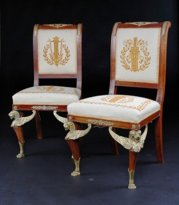 A PAIR OF EMPIRE STYLE GILT BRONZE MOUNTED MAHOGAN: A PAIR OF EMPIRE STYLE GILT BRONZE MOUNTED MAHOGANY CHAISES, each with scrolled crest rail centering a lozenge form mount enclosing Apollo's mask, flanked by anthemia and conforming leaf pendants abov