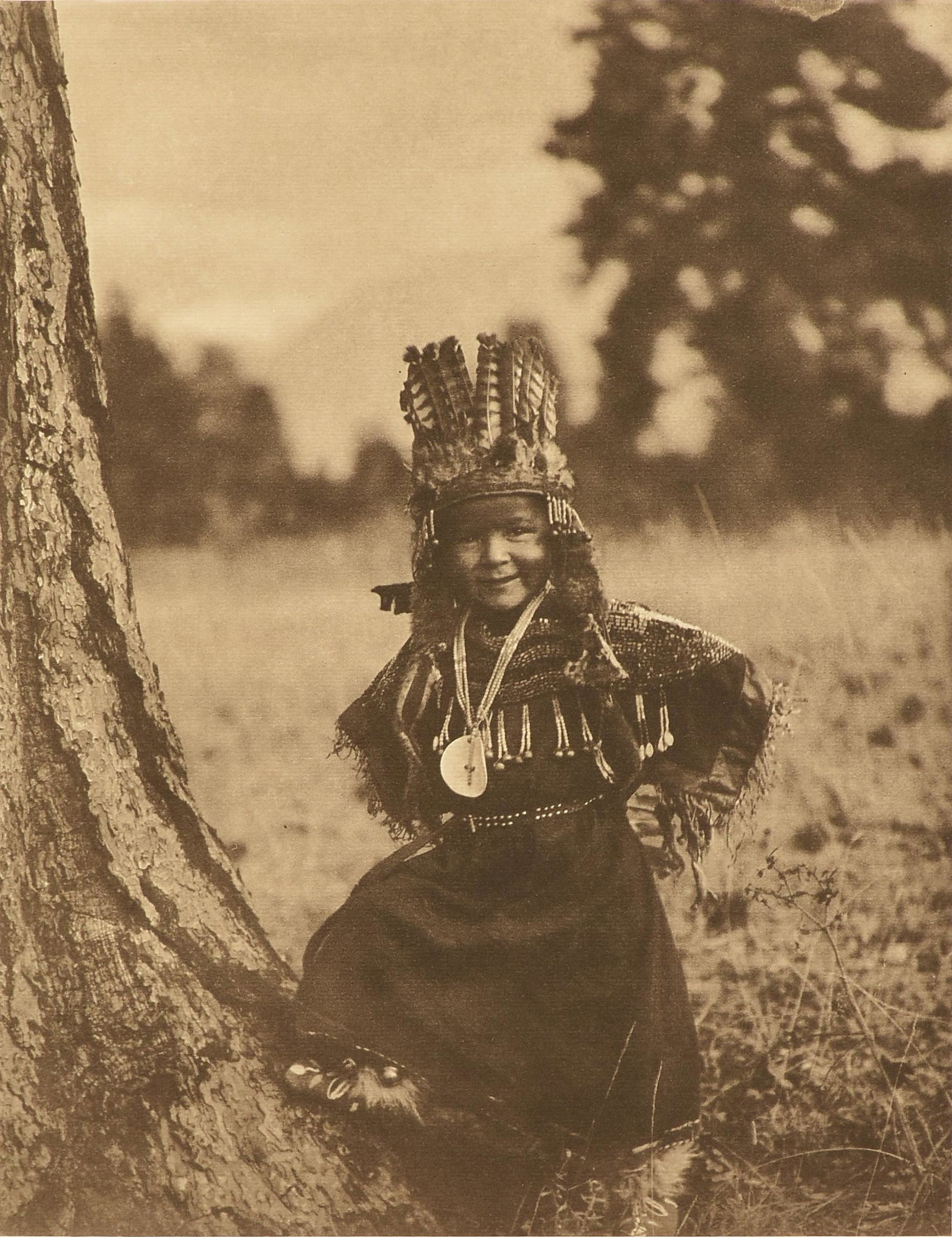 after EDWARD SHERIFF CURTIS (American 1868-1952) A: after EDWARD SHERIFF CURTIS (American 1868-1952) A PHOTOGRAPH, "Flathead Childhood," CIRCA 1911, photogravure on paper, "From Copyright Photograph 1910 by E.S. Curtis.," "Photogravure by John Andrew &