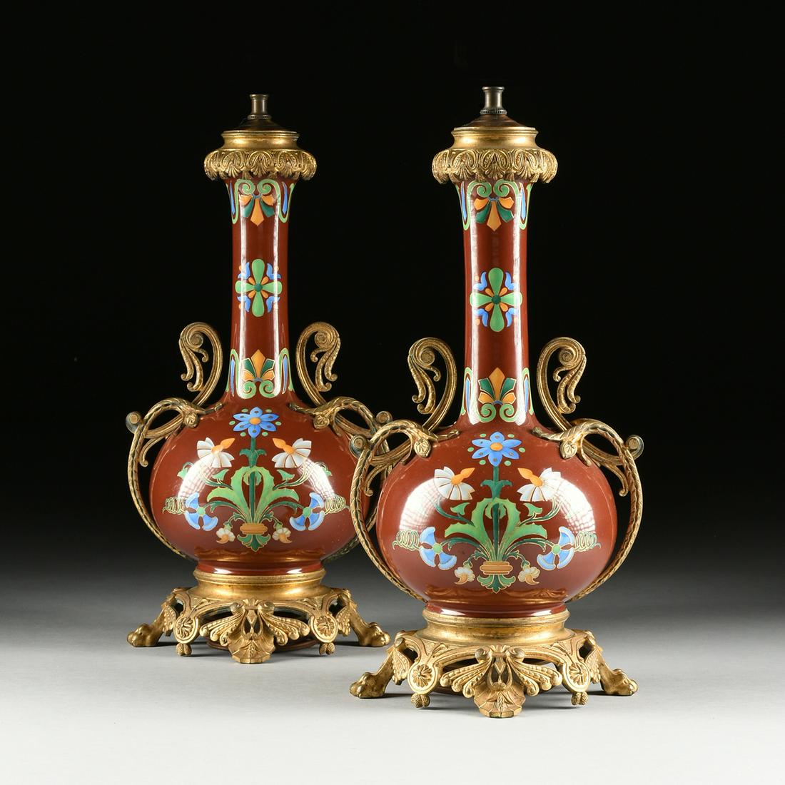 A PAIR OF SEVRES NEO-GREC STYLE GILT BRONZE MOUNTED: A PAIR OF SEVRES NEO-GREC STYLE GILT BRONZE MOUNTED SANG DE BOEUF PORCELAIN VASES, FRENCH, CIRCA 1890, the ox blood glazed bottle neck vases with globular bodies painted in trompe l'oeil, mimicking Ch