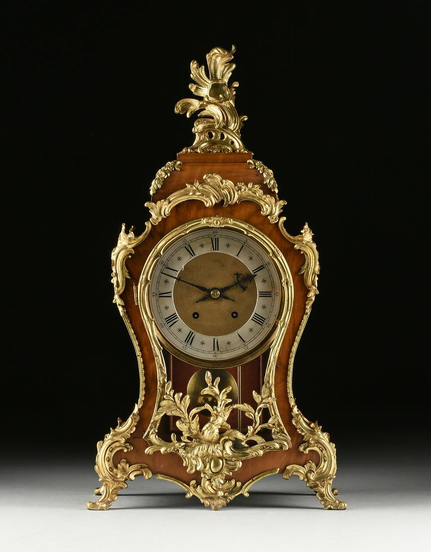 A LOUIS XV STYLE ORMOLU MOUNTED KINGWOOD BRACKET CLOCK,: A LOUIS XV STYLE ORMOLU MOUNTED KINGWOOD BRACKET CLOCK, LATE 19TH CENTURY, the tête de poupée body with an encadrement framed glass door mounted with a wilting flower and leafy stems br