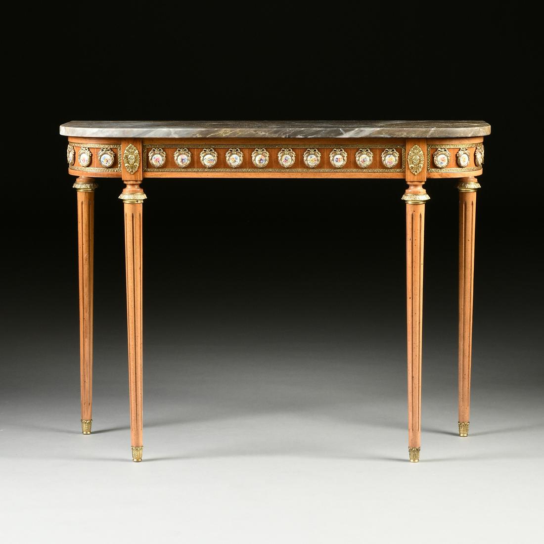 A LOUIS XVI REVIVAL STYLE MARBLE TOPPED AND PORCELAIN: A LOUIS XVI REVIVAL STYLE MARBLE TOPPED AND PORCELAIN MOUNTED BEECH CONSOLE TABLE, LATE 20TH CENTURY, with a "D" form variegated heather gray marble top above a conforming recessed mahogany paneled fr