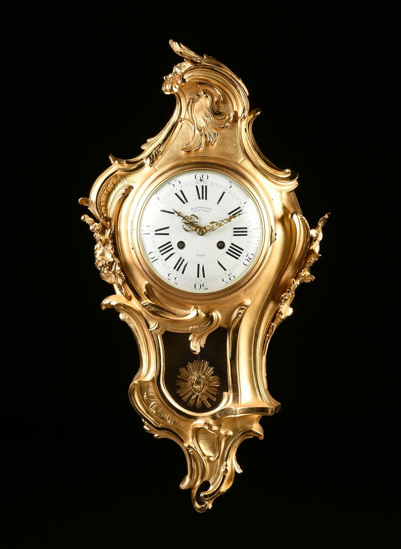 A LOUIS XV STYLE ORMOLU CARTEL CLOCK, BY DE LAFONTAINE,: A LOUIS XV STYLE ORMOLU CARTEL CLOCK, BY DE LAFONTAINE, PARIS, LATE 19TH CENTURY,, after the original cartel clock by Jacques Caffieri (French 1678-1755) and centering a circular bronze and domed glas