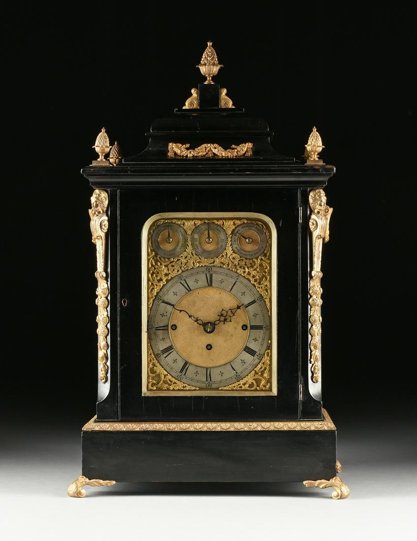 A GEORGE II STYLE GILT BRASS MOUNTED EBONIZED WOOD: A GEORGE II STYLE GILT BRASS MOUNTED EBONIZED WOOD TABLE CLOCK, SECOND HALF 19TH CENTURY, of rectangular form with a pineapple finial on short pedestal flanked by scrolled brackets supported by a cush