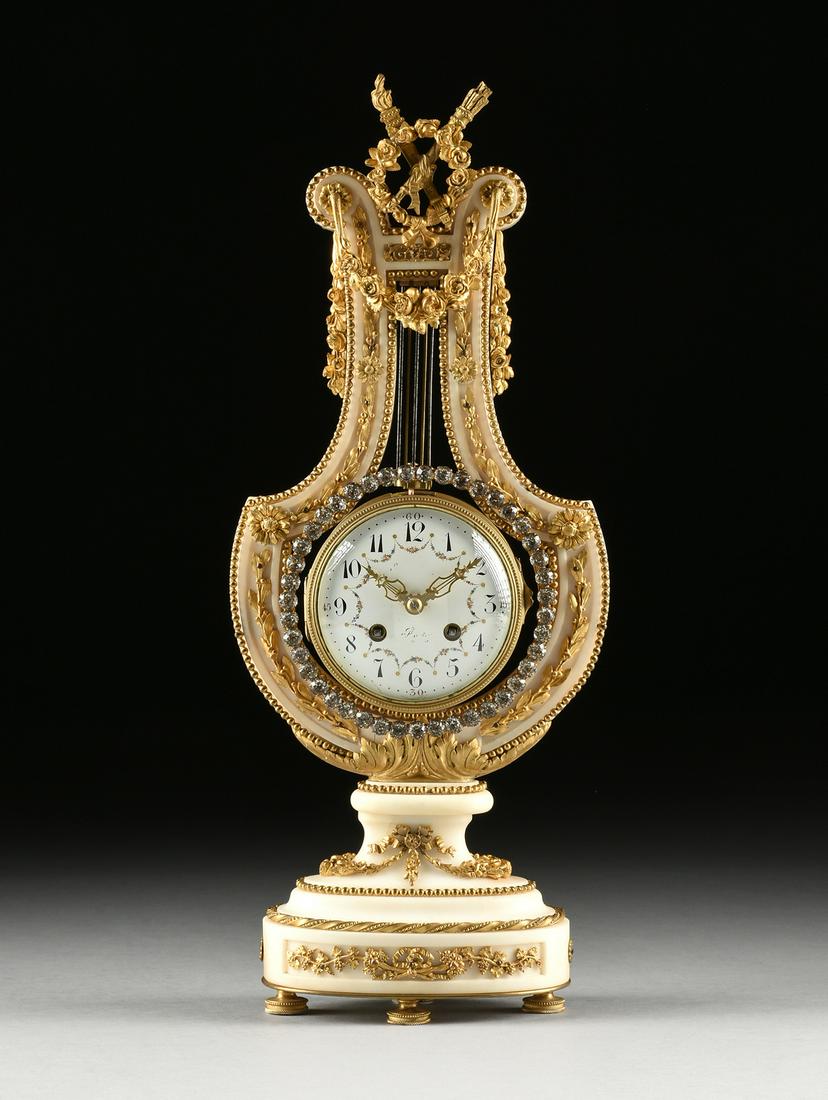 A LOUIS XVI STYLE ORMOLU AND FAUX BRILLIANTS MOUNTED: A LOUIS XVI STYLE ORMOLU AND FAUX BRILLIANTS MOUNTED LYRE FORM MARBLE MANTLE CLOCK, LATE 19TH/EARLY 20TH CENTURY, the hinged bronze and glass bezel opening to a circular enameled dial, enclosing black