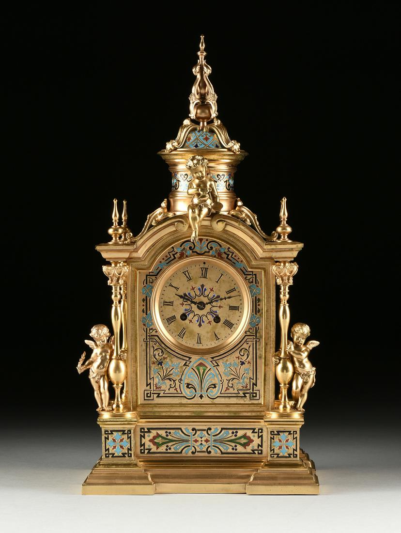 A NAPOLEON III CHAMPLEVE ENAMELED GILT BRONZE MANTLE: A NAPOLEON III CHAMPLEVE ENAMELED GILT BRONZE MANTLE CLOCK, MID 19TH CENTURY, the circular dial with black Roman chapters enclosing an enameled floret centering black steel hands over twin key escapem