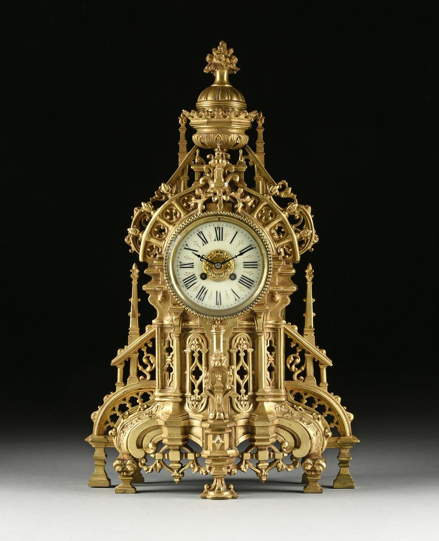 A GOTHIC REVIVAL BRONZE MANTLE CLOCK, FRENCH, THIRD: A GOTHIC REVIVAL BRONZE MANTLE CLOCK, FRENCH, THIRD QUARTER 19TH CENTURY, in the Flamboyant Gothic architectural style with an elaborately cast case surmounted by a coronet ringed urn with domed lid a