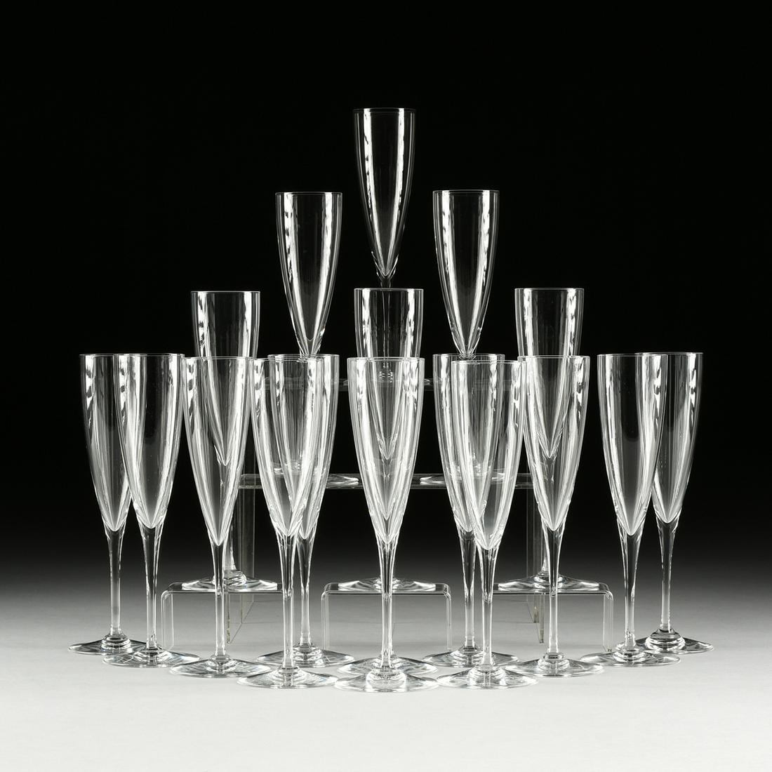 A SET OF EIGHTEEN BACCARAT "DOM PERIGNON" CRYSTAL: A SET OF EIGHTEEN BACCARAT "DOM PERIGNON" CRYSTAL CHAMPAGNE FLUTES, LATE 20TH CENTURY, each with 5-ounce flute, verso Baccarat acid-etched mark. Height: 9 1/4" Provenance: Property from a Promin