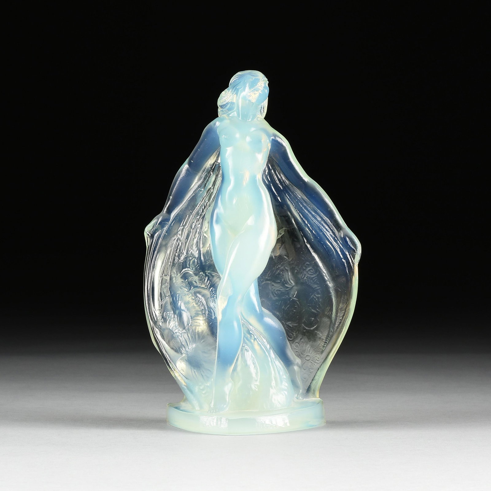 A SABINO "NUDE DANCER" GLASS SCULPTURE, SIGNED, FRENCH,: A SABINO "NUDE DANCER" GLASS SCULPTURE, SIGNED, FRENCH, 20TH CENTURY, molded opalescent glass, engraved at base and in relief, "Sabino France." Height: 9 1/4" Diameter: 6" Provenance: Private Collecti