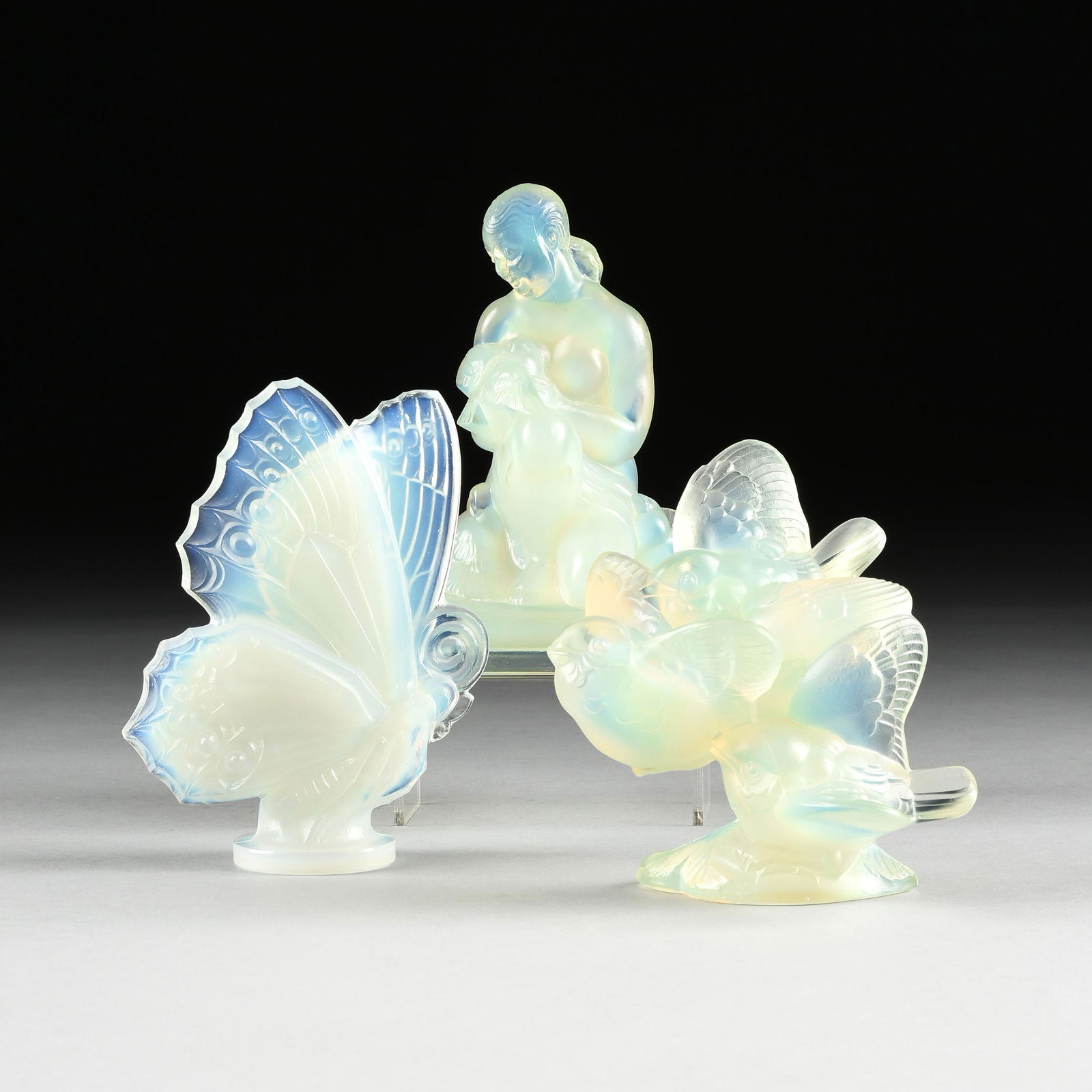 A GROUP OF THREE SABINO GLASS SCULPTURES, FRENCH, 20TH: A GROUP OF THREE SABINO GLASS SCULPTURES, FRENCH, 20TH CENTURY, opalescent glass, comprising "Lady and Doves," a crouching nude in the Art Deco taste, signed at plinth back, "Sabino Paris," with stick