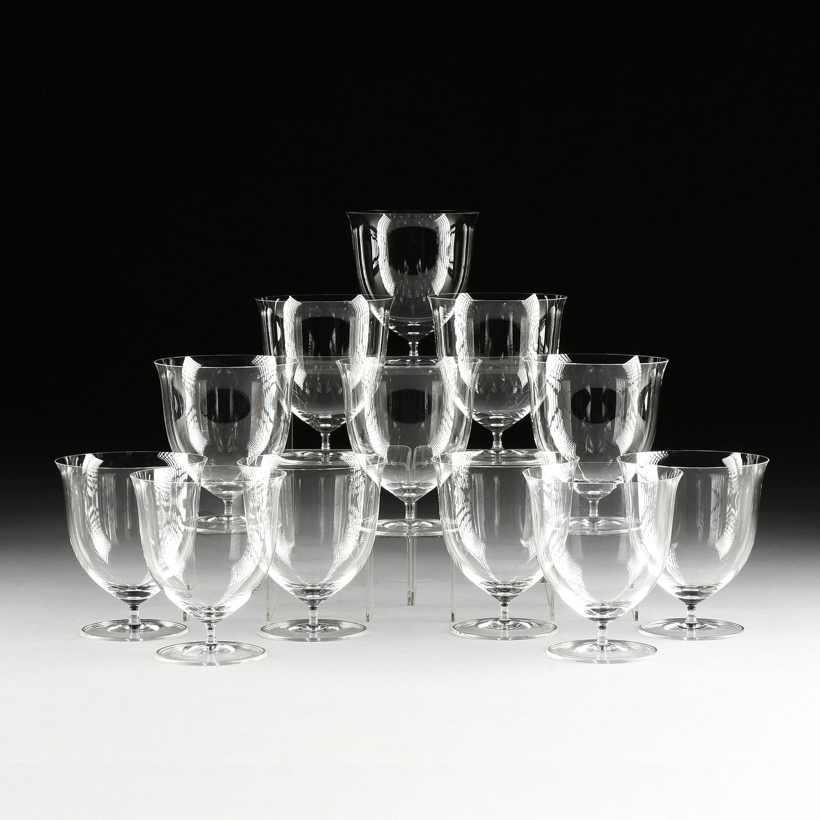 A SET OF TWELVE LOBMEYR "PATRICIAN" FLOWER VASES: A SET OF TWELVE LOBMEYR "PATRICIAN" FLOWER VASES STEMWARE, JOSEPH HOFFMAN, AUSTRIAN, DESIGNED 1917, blown molded muslin glass with clear flared bowls on stems. Height:5 3/4" Diameter: 5" Note: The Pat