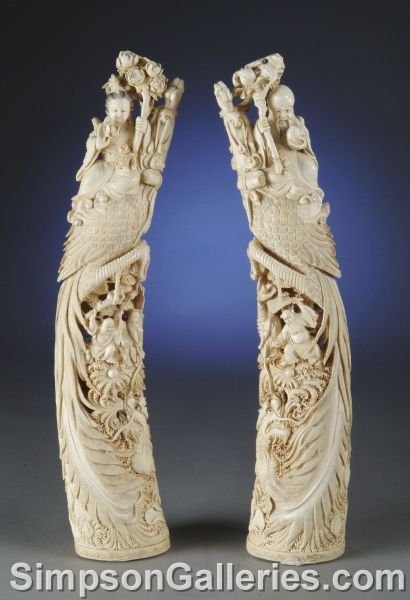 AN IMPORTANT PAIR OF CHINESE IVORY CARVINGS, each : AN IMPORTANT PAIR OF CHINESE IVORY CARVINGS, each from a single tusk, one of Ho Hsien-Ku holding a lotus branch and seated on a phoenix whilst below the immortals Li T'ieh-Kuai and Chang Kuo-lao confr