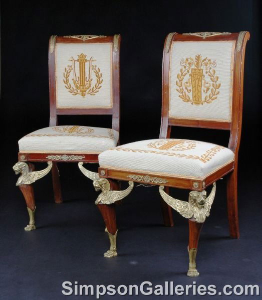 A PAIR OF EMPIRE STYLE GILT BRONZE MOUNTED MAHOGAN: A PAIR OF EMPIRE STYLE GILT BRONZE MOUNTED MAHOGANY CHAISES, each with scrolled crest rail centering a lozenge form mount enclosing Apollo's mask, flanked by anthemia and conforming leaf pendants abov