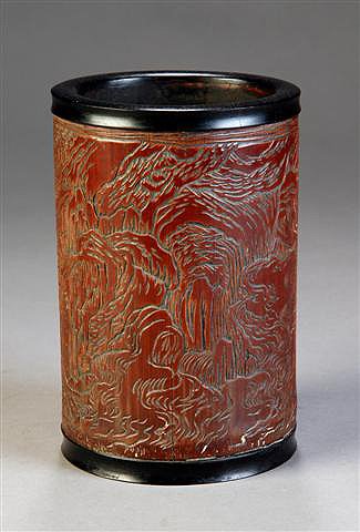 AN ANTIQUE CHINESE CARVED BAMBOO BRUSH POT, dated 1: AN ANTIQUE CHINESE CARVED BAMBOO BRUSH POT, dated 1743, signed Zhou Zhiyan, of cylindrical form and carved with trees in a mountainous landscape. Height: 7", diameter: 4 1/2".
