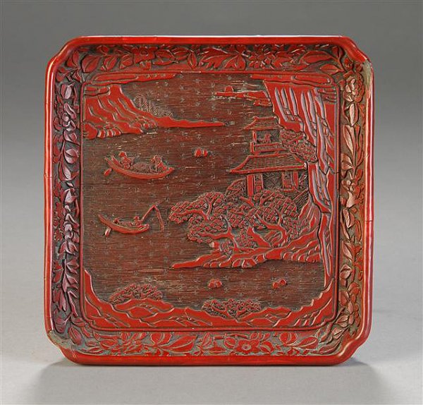 A CHINESE CINNABAR DISH, Ming Dynasty, 16th/17th c: A CHINESE CINNABAR DISH, Ming Dynasty, 16th/17th century, carved with fishermen in boats and a scholar in a pavilion by the lake, with a register of flowering branches. Some damage at corners. Length: