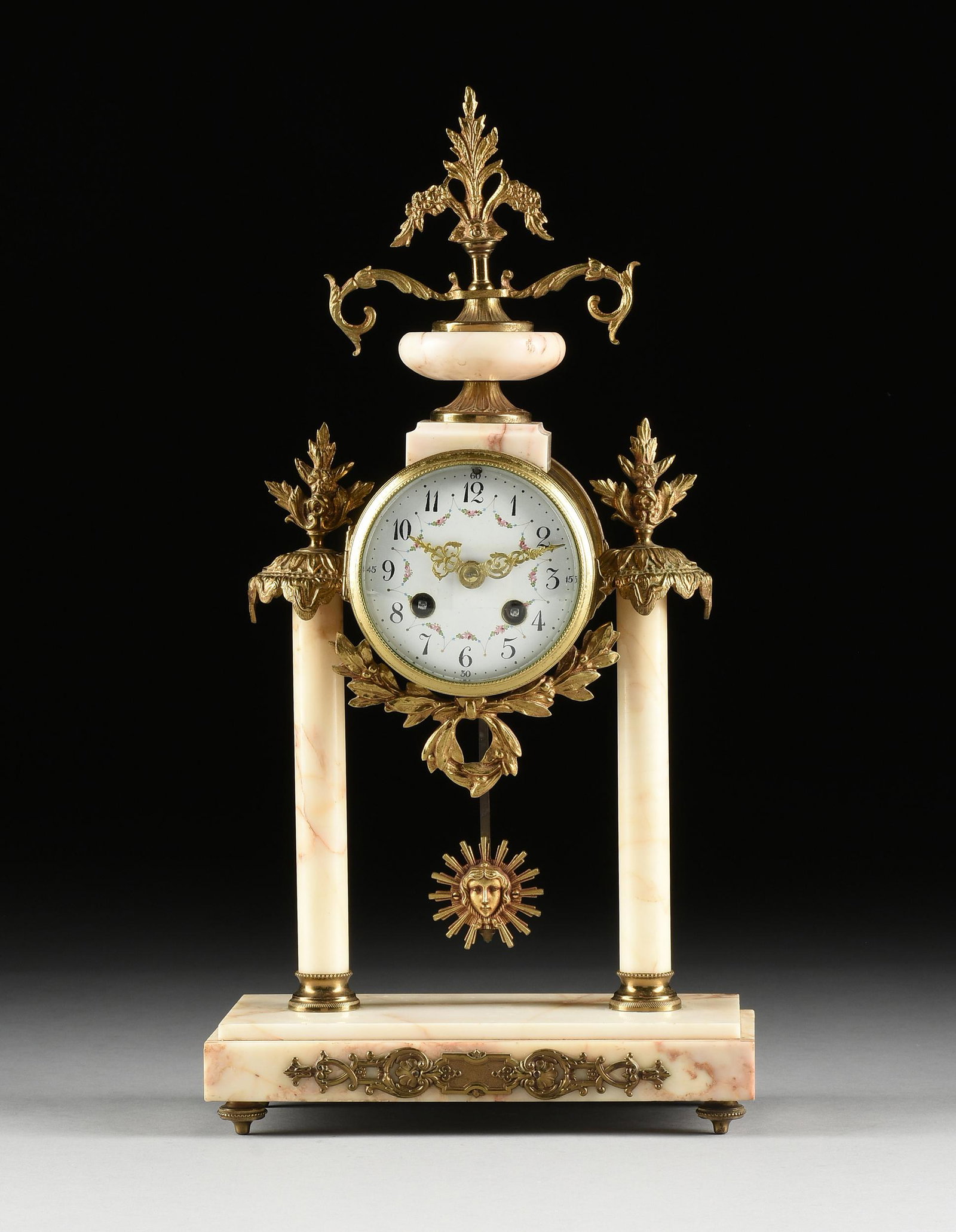 A LOUIS XVI REVIVAL GILT BRONZE AND MARBLE CLOCK,: A LOUIS XVI REVIVAL GILT BRONZE AND MARBLE CLOCK, CLOCKWORKS BY FRITZ MARTI, FRENCH, CIRCA 1900, the gilt brass cylindrical case centering a convex glass and beaded bronze bezel, opening to a white en