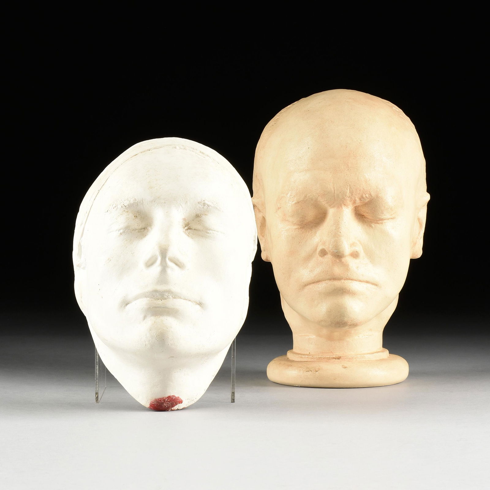 A GROUP OF TWO ENGLISH PLASTER LIFE MASK REPLICAS OF: A GROUP OF TWO ENGLISH PLASTER LIFE MASK REPLICAS OF WILLIAM BLAKE AND JOHN KEATS, CIRCA 1999, the William Blake life mask/bust replica on an integral circular socle with light fawn tinting throughout