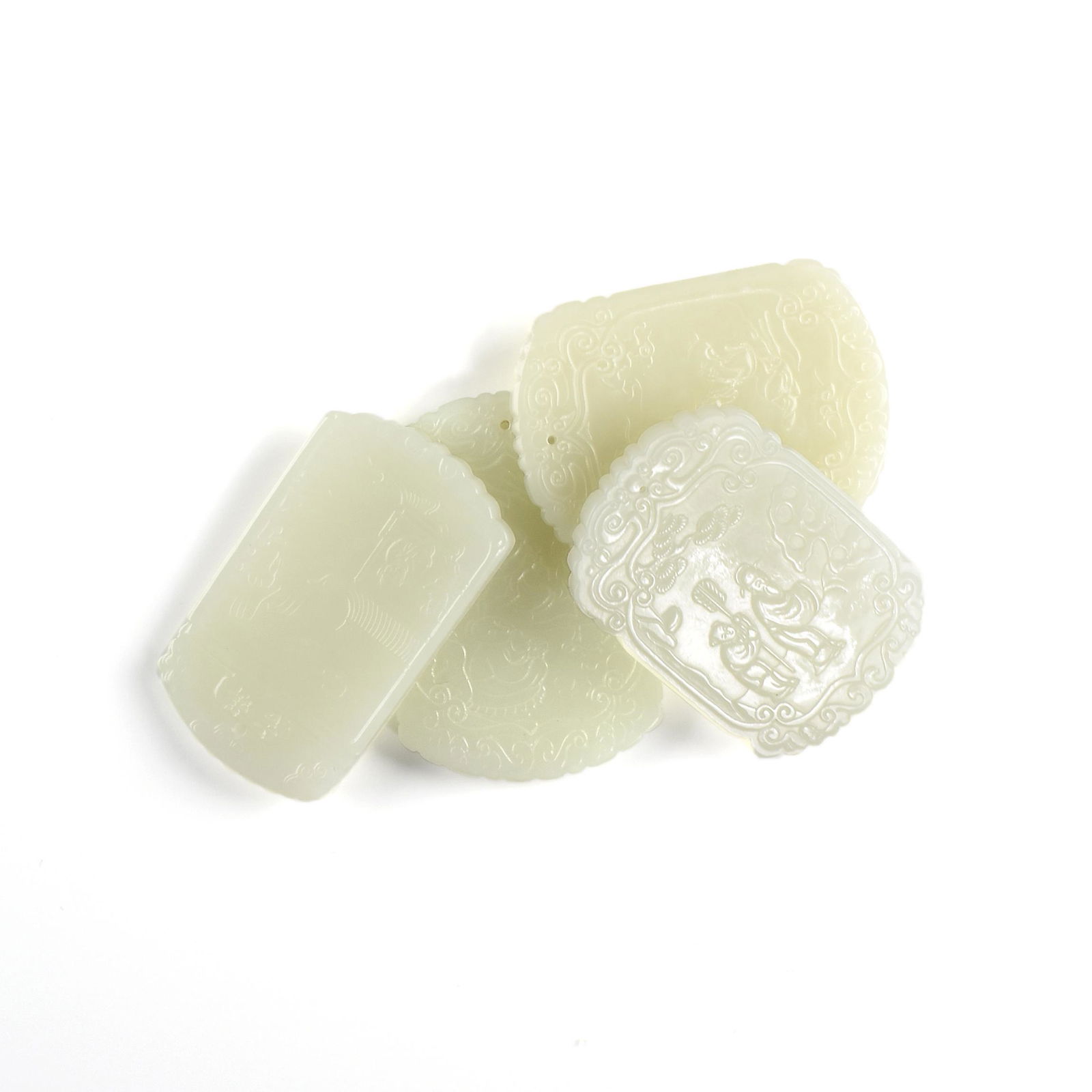 A GROUP OF FOUR CELADON AND WHITE JADE FIGURAL PLAQUES, (1 of 9)