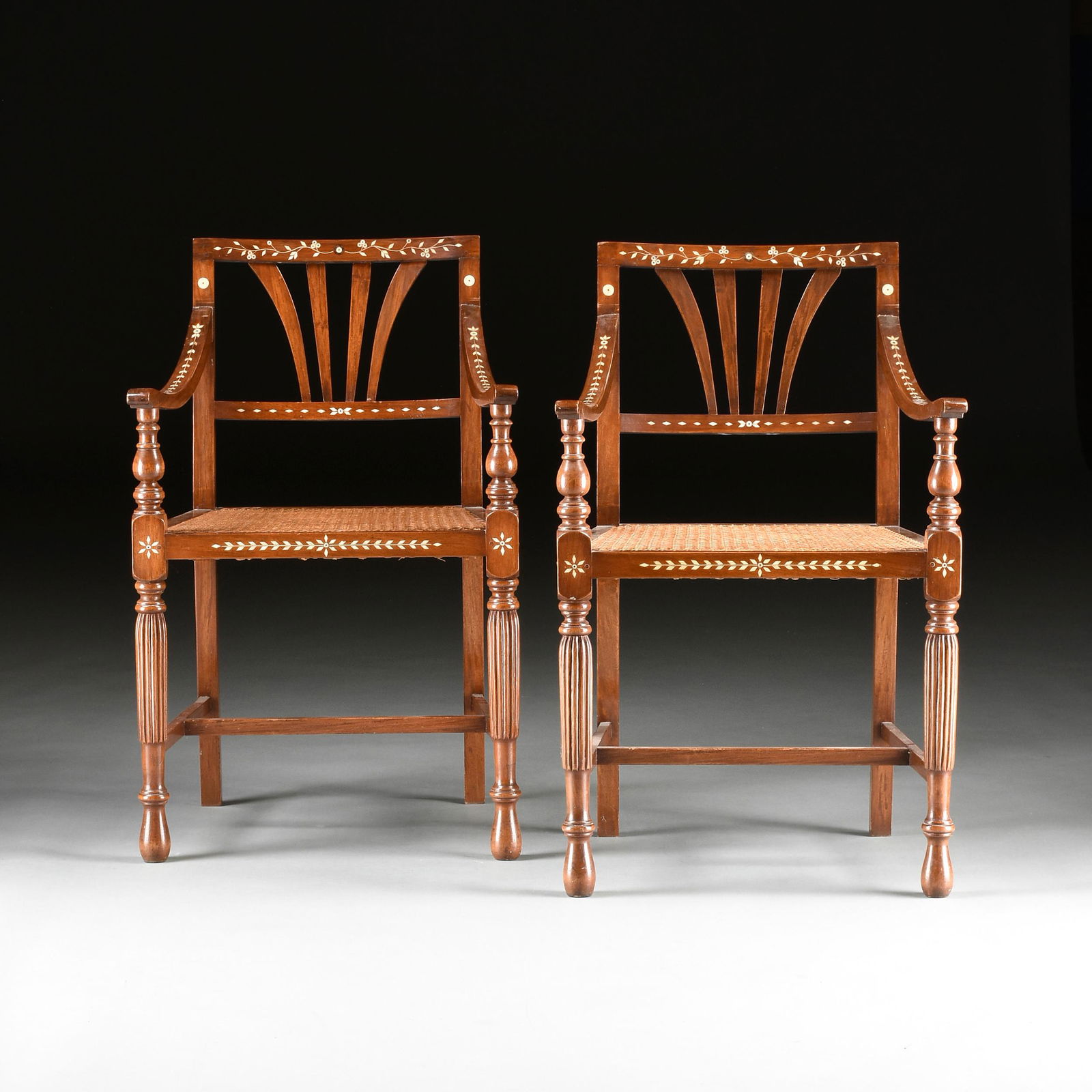 A SET OF SIX SPANISH COLONIAL FILIPINO BONE INLAID AND: A SET OF SIX SPANISH COLONIAL FILIPINO BONE INLAID AND CANED NARRA WOOD ARMCHAIRS, BULACAN PROVINCE, EARLY 19TH CENTURY, each with a contoured rectangular crest rail centering undulating berried leafy