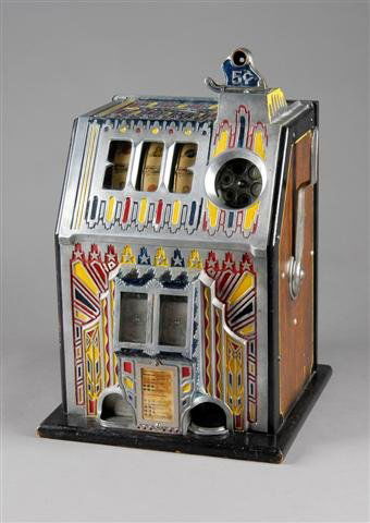 A PACE COMET 5 CENT THREE REEL SLOT MACHINE. Circa: A PACE COMET 5 CENT THREE REEL SLOT MACHINE. Circa 1932, made by the Pace Mfg. Co. It has the original cash box, lock, and key. The front has a starburst painted design. It has a twin jackpot. When a