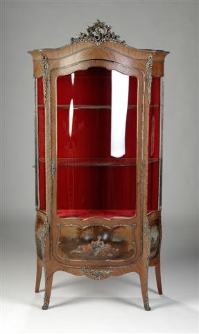 A LOUIS XV GILT BRONZE MOUNTED TULIPWOOD VITRINE, : A LOUIS XV GILT BRONZE MOUNTED TULIPWOOD VITRINE, the arched cornice centering a scrolling acanthus and rocaille cast pendant above a bombé glazed door with lower painted panel depicting a courting c