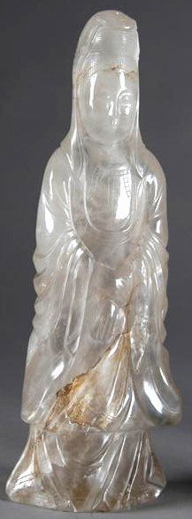 A QING DYNASTY ROCK CRYSTAL CARVING OF QUAN YIN ca: A QING DYNASTY ROCK CRYSTAL CARVING OF QUAN YIN carved in relief with left and right hand together, and wearing a long flowing robe. Height: 11".