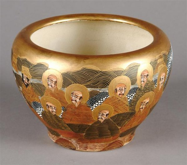 A FINE EDO PERIOD EARTHENWARE BOWL, the sides enam: A FINE EDO PERIOD EARTHENWARE BOWL, the sides enameled with Rakan within a surround of official attendants. Height: 5", diameter: 7".