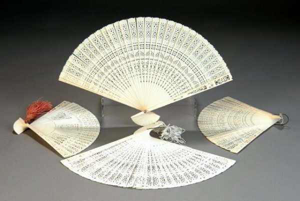 FOUR CHINESE CANTON CARVED IVORY FANS, early 20th : FOUR CHINESE CANTON CARVED IVORY FANS, early 20th century, each with reticulated blades of stylized foliage and geometric patterns. The tallest height: 9". (4)