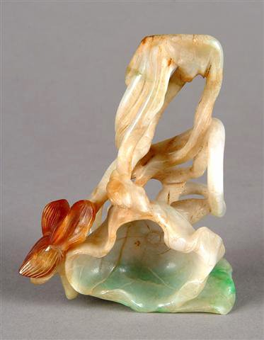 AN ANTIQUE CARVED JADEITE BRUSH WASHER, Qing Dynas: AN ANTIQUE CARVED JADEITE BRUSH WASHER, Qing Dynasty, 19th century, finely carved as a reticulated lotus blossom. Length: 4 1/2".