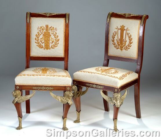 A PAIR OF EMPIRE STYLE GILT BRONZE MOUNTED MAHOGANY: A PAIR OF EMPIRE STYLE GILT BRONZE MOUNTED MAHOGANY CHAISES, each with scrolled crest rail centering a lozenge form mount enclosing Apollo's mask, flanked by anthemia and conforming leaf pendants abov