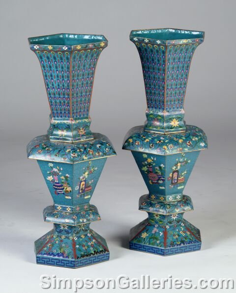 A PAIR OF CHINESE TURQUOISE GROUND AND COLORFULLY : A PAIR OF CHINESE TURQUOISE GROUND AND COLORFULLY ENAMELED CLOISONNÉ VASES, 20th century, the hexagonal rim on conforming sides with a long tapering neck enclosing rows of beads and balls above a col