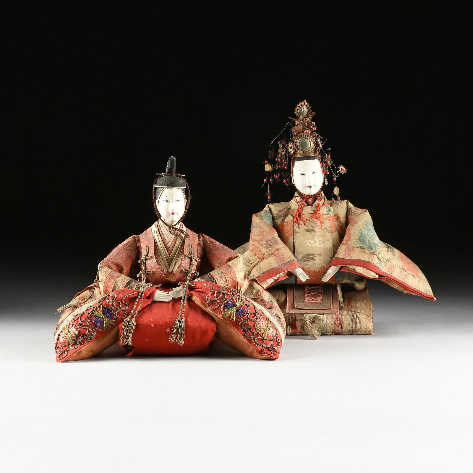 A PAIR OF JAPANESE HINAMATSURI DOLLS IN TRADITIONAL: A PAIR OF JAPANESE HINAMATSURI DOLLS IN TRADITIONAL HEIAN DRESS, MEIJI PERIOD (1867-1912), silk, gilt couched thread, natural fibers, glass eyes and gofun ground oyster shell painted face. Height: 16"