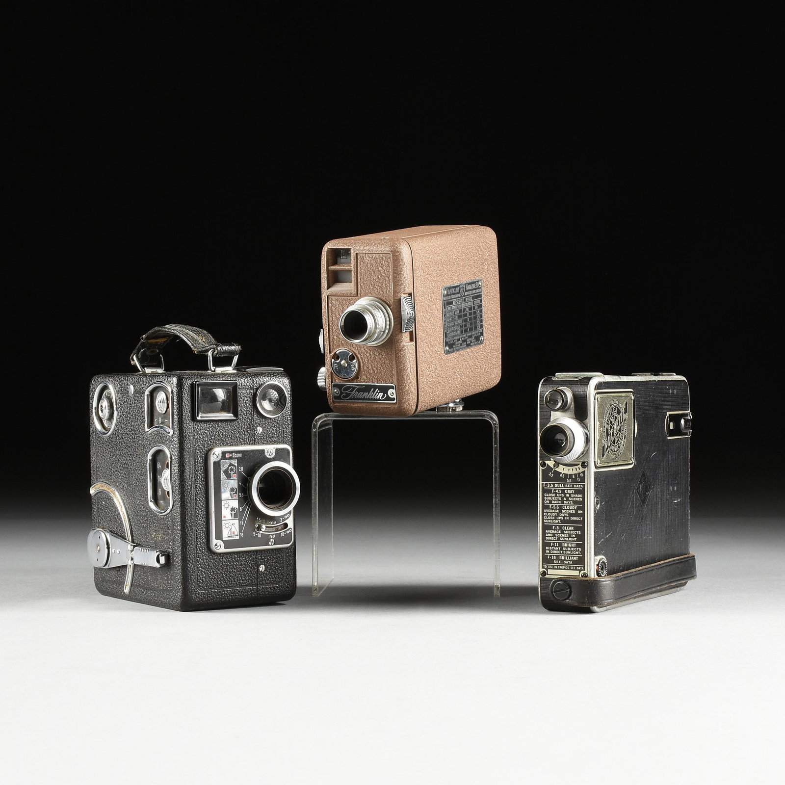A GROUP OF THREE MOVIE CAMERAS, 1930-1950,: A GROUP OF THREE MOVIE CAMERAS, 1930-1950, comprising a?Franklin Photographic Magazine 8 - Model 115, with brown coated case, licensed under Eastman Kodak?patents, 1938-1942, height: 4", width: 2 1/2"