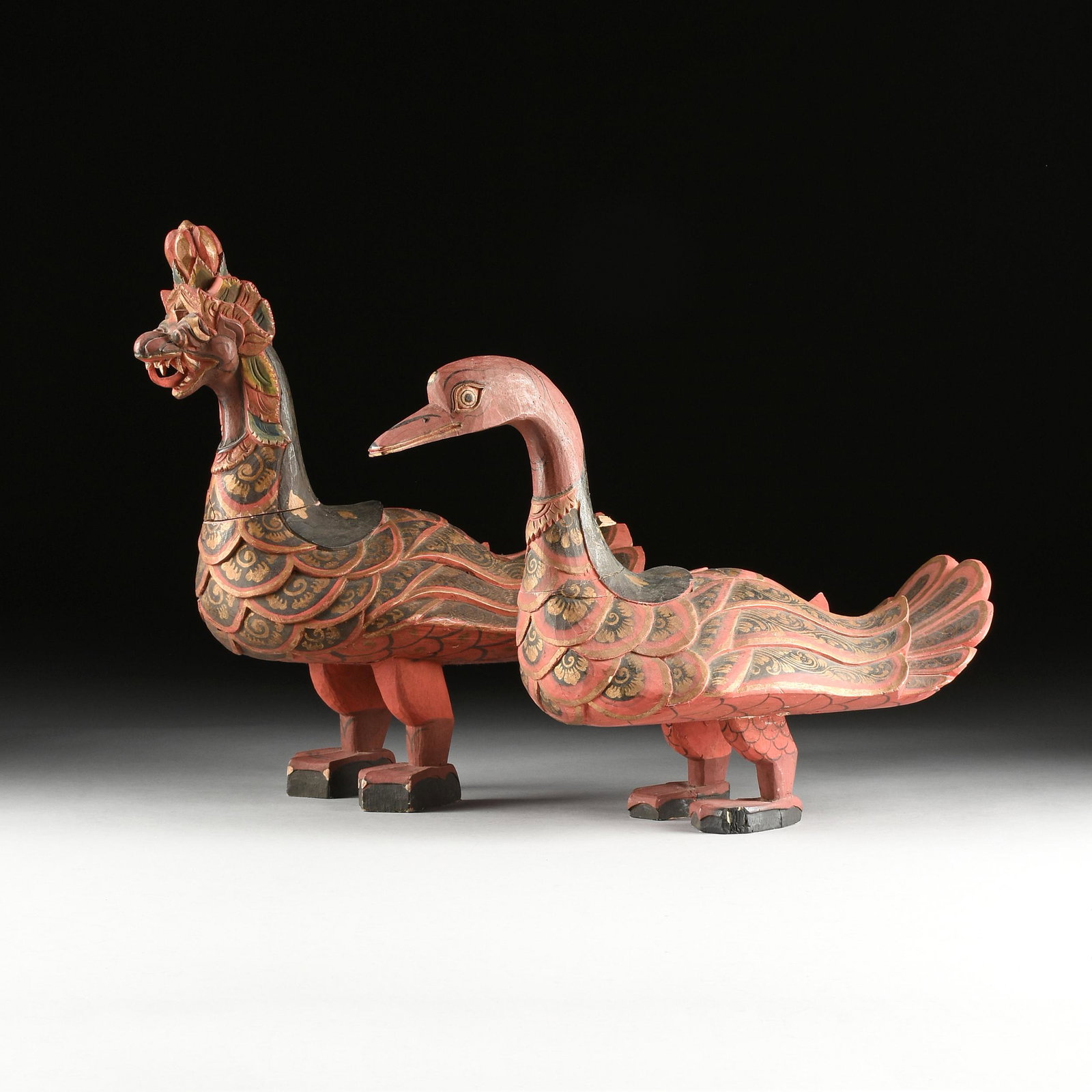 A PAIR OF BURMESE PAINTED WOOD HINTHA SWAN CEREMONIAL: A PAIR OF BURMESE PAINTED WOOD HINTHA SWAN CEREMONIAL RELIQUARY BOXES, MAYANMAR, EARLY/MID 20TH CENTURY, gilt, lacquer and pigment, both with small removable lids at the backs opening to jewelry (ring