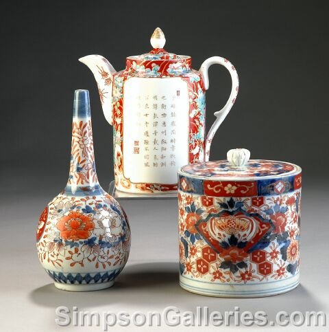 A GROUP OF THREE ANTIQUE JAPANESE IMARI PORCELAIN W: A GROUP OF THREE ANTIQUE JAPANESE IMARI PORCELAIN WARES, Meiji Period (1868-1912), each decorated in traditional colors comprising a bottle vase, height: 10"; a teapot, height: 9"; and a biscuit box. 