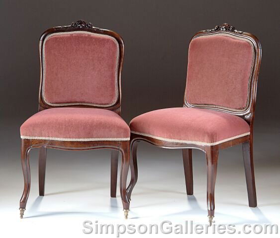 A PAIR OF LOUIS PHILIPPE CARVED CHESTNUT CHAISES À: A PAIR OF LOUIS PHILIPPE CARVED CHESTNUT CHAISES À LA REINE, second quarter 19th century, each with a serpentine rectangular padded back rest, beneath a crest rail centering a foliate pendant above a