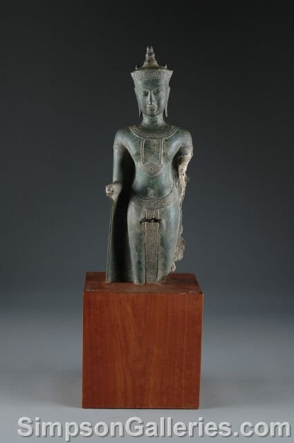 AN ANTIQUE HAI VERDIGRIS BRONZE FIGURE OF BUDDHA, : AN ANTIQUE HAI VERDIGRIS BRONZE FIGURE OF BUDDHA, late 19th/early 20th century, modeled in a standing position and raised on a rectangular teak plinth. Height: 25 1/2", width: 8 1/4", depth: 7".