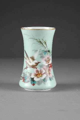 A VICTORIAN PALE GREEN GROUND MILK GLASS VASE by S: A VICTORIAN PALE GREEN GROUND MILK GLASS VASE by Smith Brothers, second half 19th century, the colorfully painted floral spray framing a small wren beneath a gilt rim, signed Smith Bros. Height: 7".
