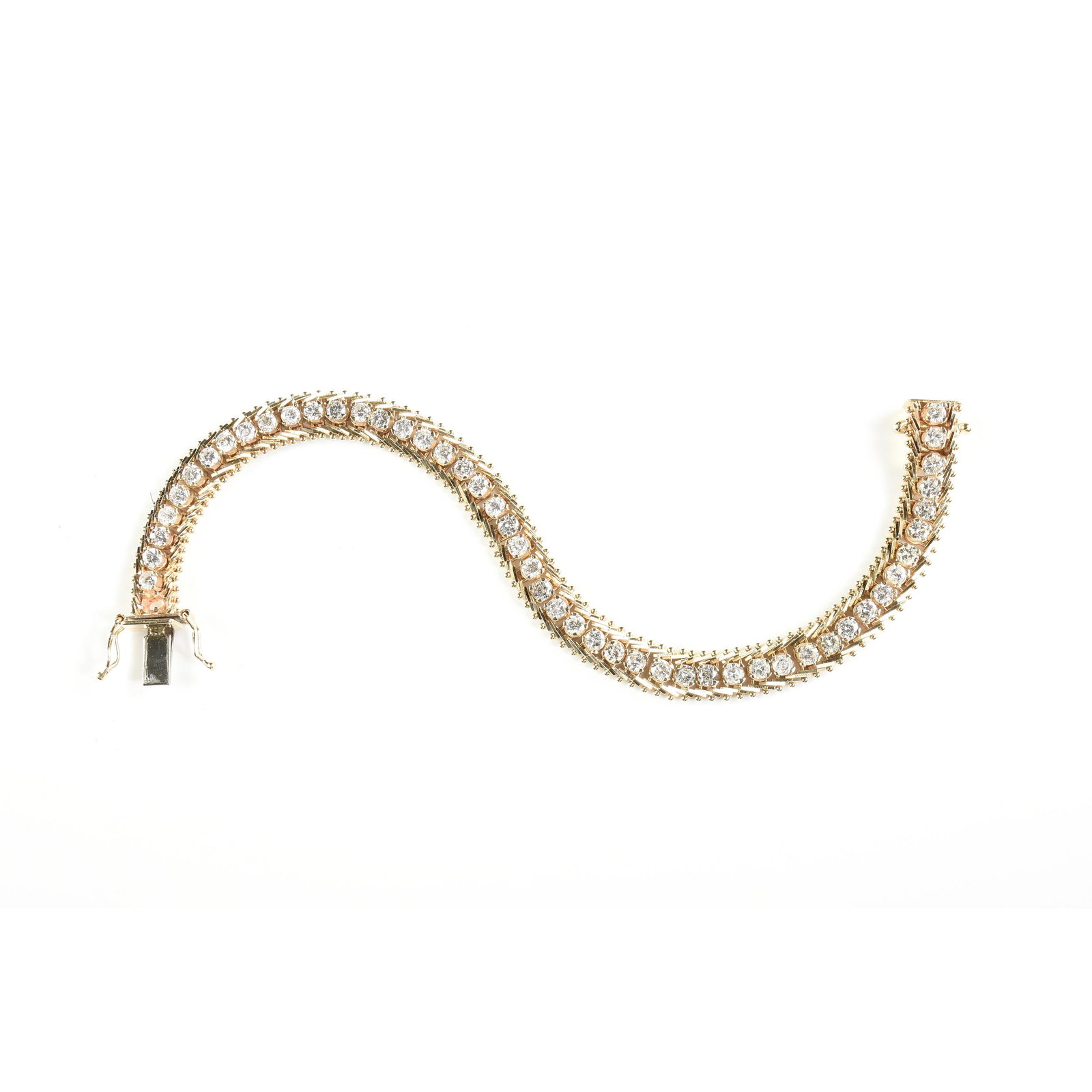 A 14K YELLOW GOLD, DIAMOND TENNIS BRACELET,: A 14K YELLOW GOLD, DIAMOND TENNIS BRACELET, the forty-nine 0.08 ct. round brilliant cut prong set diamonds on a gold chain are attached with a hidden box clasp with safety latches, marked "14K I.G. U.