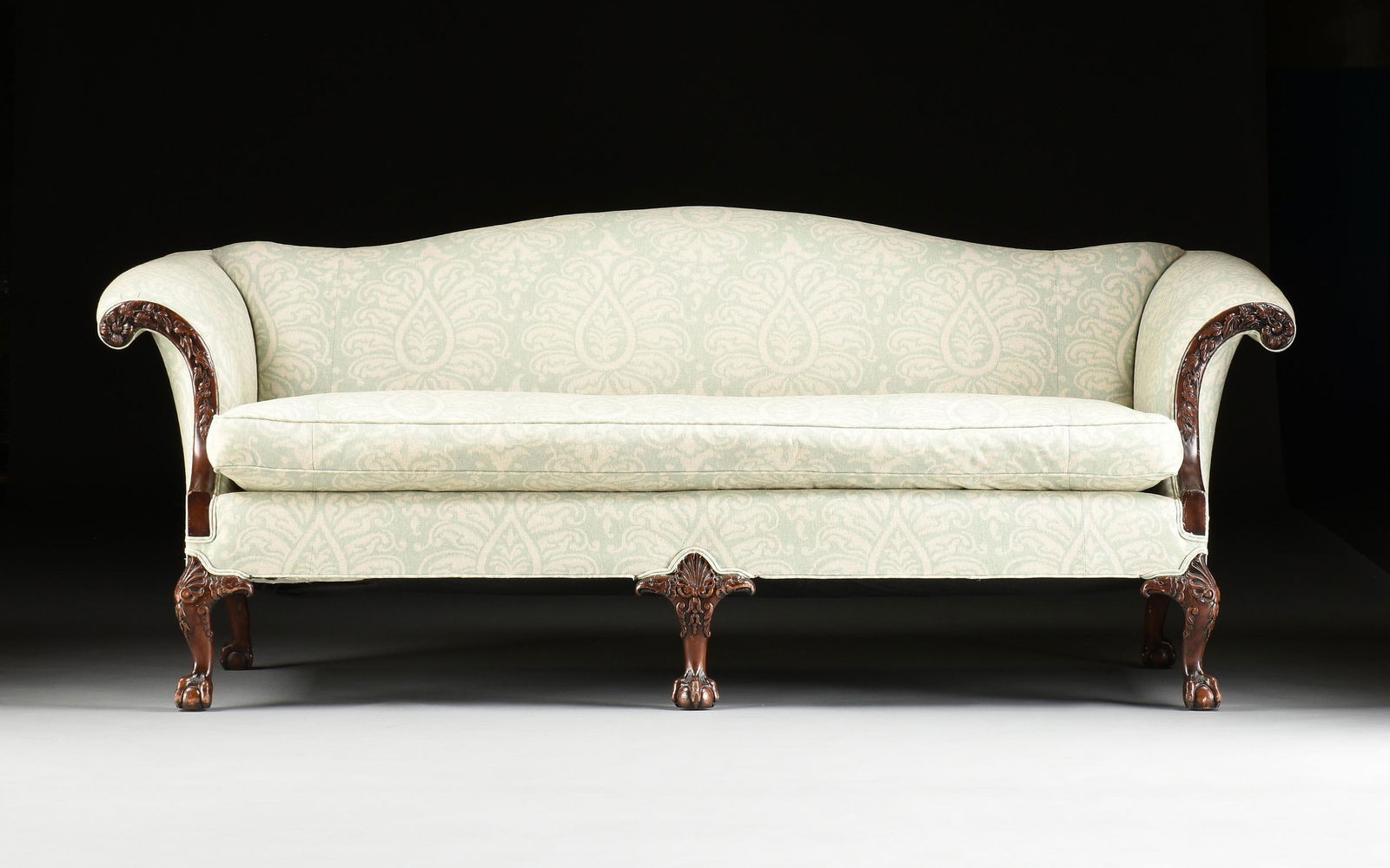 A GEORGE II STYLE UPHOLSTERED AND CARVED MAHOGANY SOFA, (1 of 6)