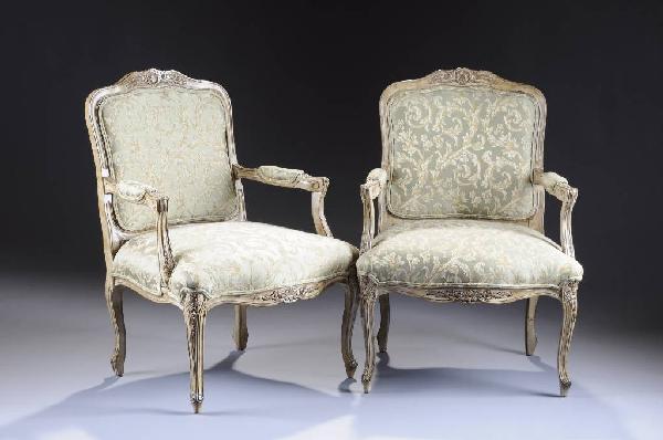 A PAIR OF LOUIS XXV STYLE CARVED AND PAINTED FAUTEU: A PAIR OF LOUIS XXV STYLE CARVED AND PAINTED FAUTEUILS by Woodmark, Howard Miller Company, each foliate carved serpentine crest rail above a padded backrest continuing down to padded armrests, the tra