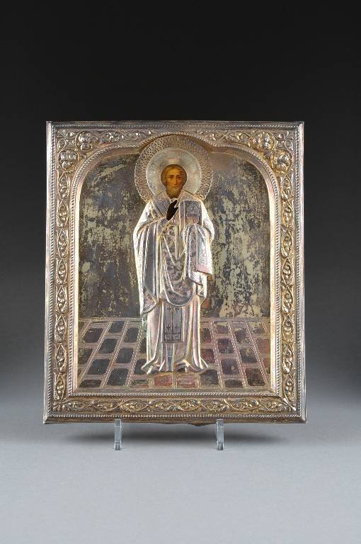 A RUSSIAN ICON OF A SAINT WITHIN A SILVER GILT OKL: A RUSSIAN ICON OF A SAINT WITHIN A SILVER GILT OKLAD, CYRILLIC MAKER'S INITIALS "AY," MOSCOW, 1908-1926, possibly depicting St. Nicholas with finely painted face beneath a reticulated halo engraved wi