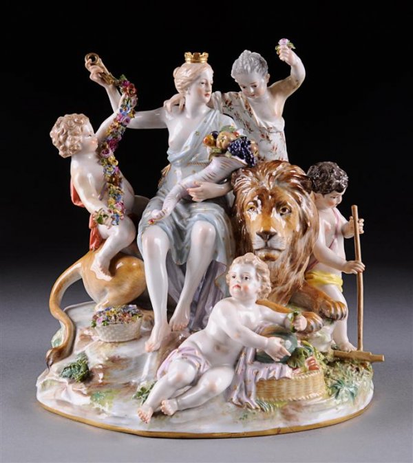 A MEISSEN FIGURAL GROUP EMBLEMATIC OF EARTH, LATE : A MEISSEN FIGURAL GROUP EMBLEMATIC OF EARTH, LATE 19TH/EARLY 20TH CENTURY, modeled as the classically attired goddess Cybele holding aloft a key and cradling a fruit filled cornucopia while seated on 