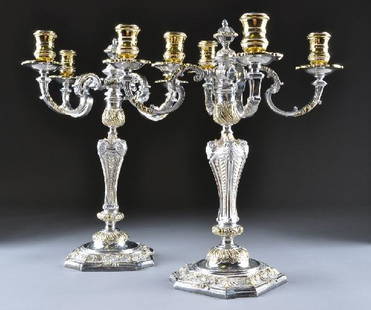 A PAIR OF ASPREY STERLING SILVER FOUR LIGHT CANDEL: A PAIR OF ASPREY STERLING SILVER FOUR LIGHT CANDELABRA, each standard comprising baroque influence over lapping husk, everted shells and foliate scrolls, with vermeil highlights, the scrolling foliate