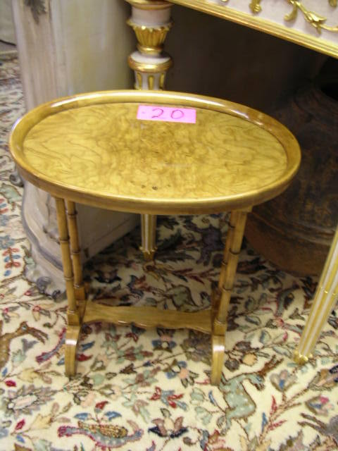 A burled olive wood occasional table by Baker, the