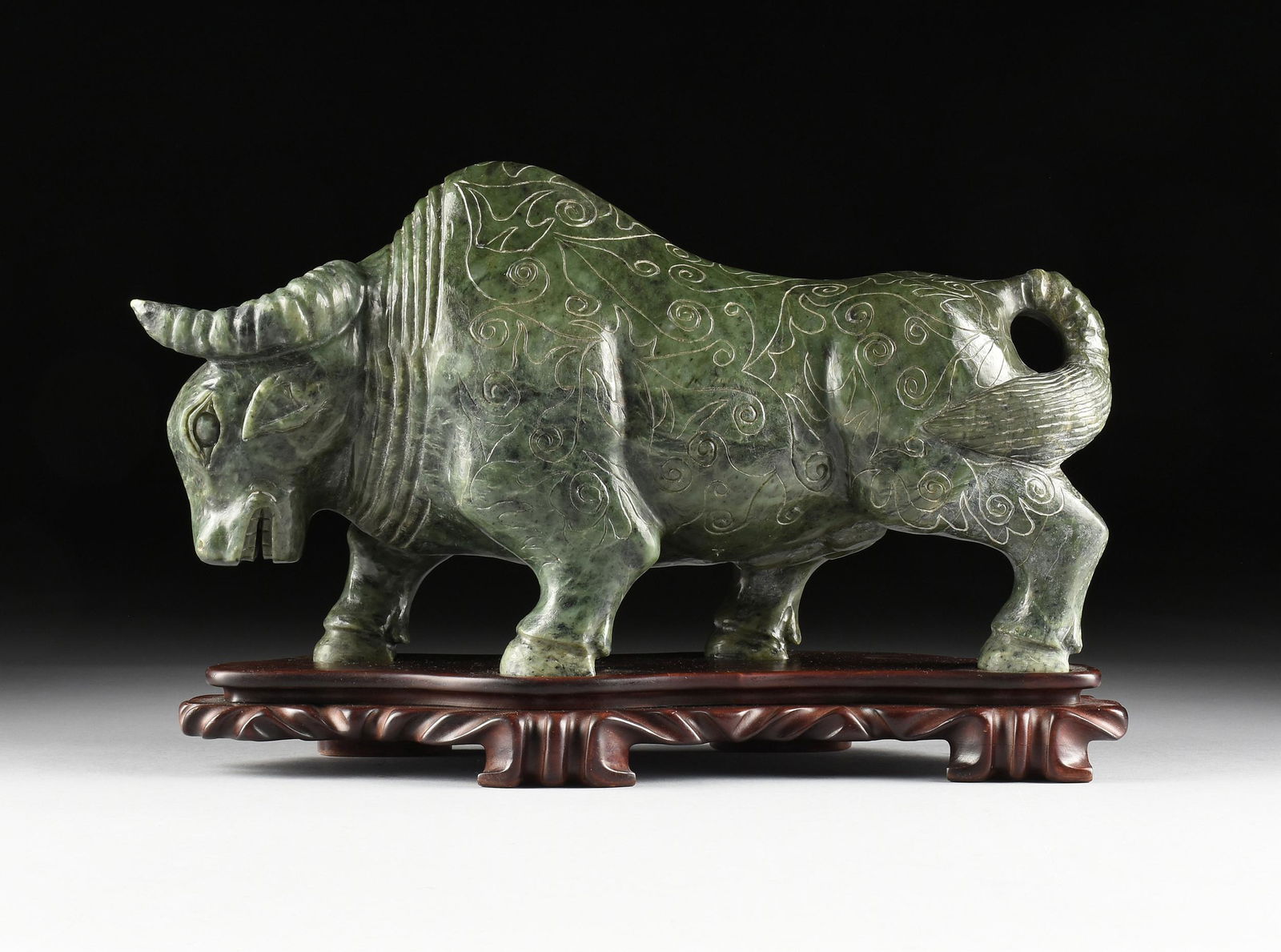 A LARGE CHINESE CARVED DARK GREEN BOWENITE JADE BULL (1 of 10)