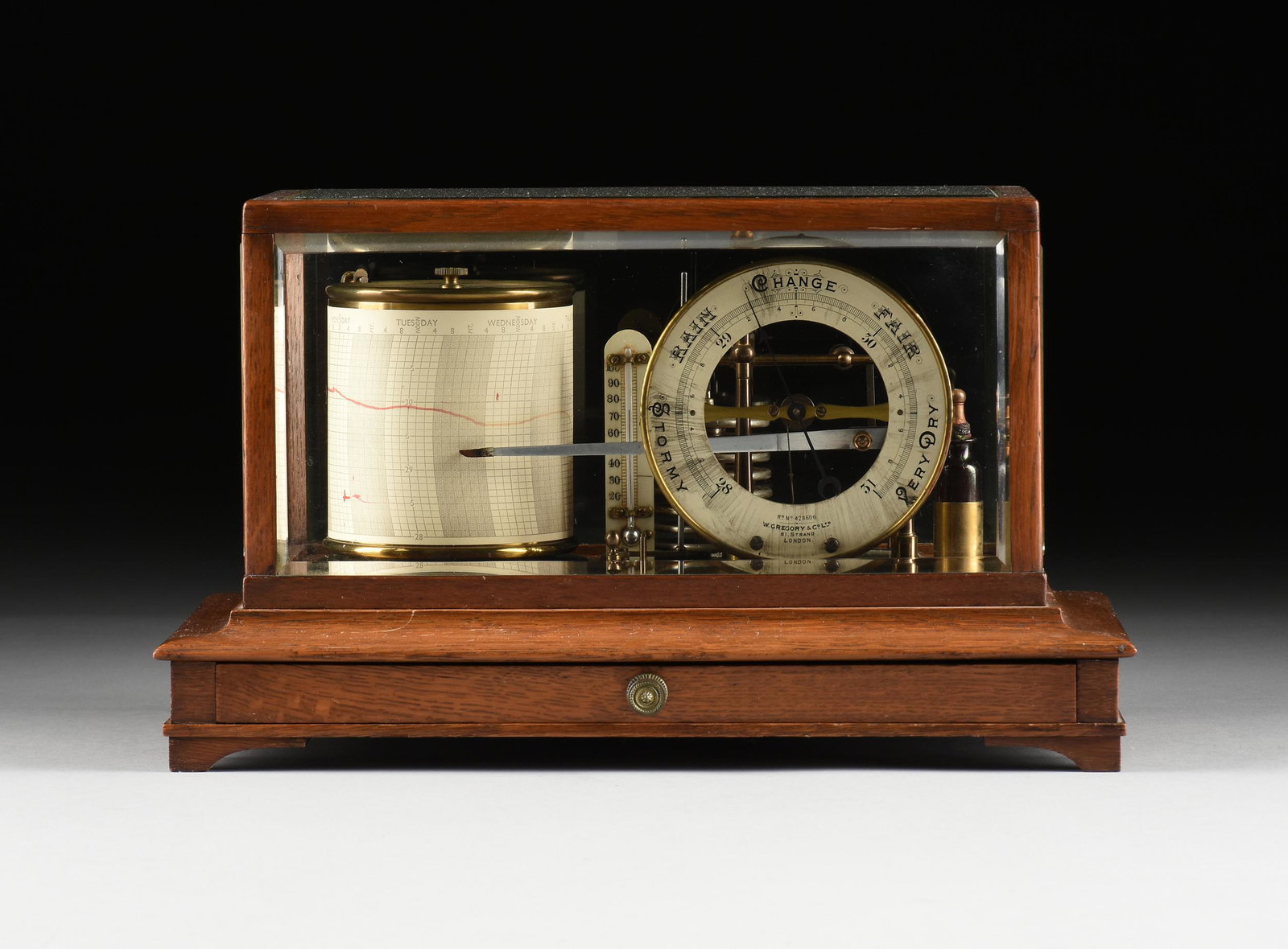 AN ENGLISH OAK AND GLASS CASED BAROGRAPH WITH BAROMETER: AN ENGLISH OAK AND GLASS CASED BAROGRAPH WITH BAROMETER DIAL, BY W. GREGORY & CO. LTD, LONDON, 19TH CENTURY, the rectangular golden oak and beveled glass case covering a lacquered and grained brass ei