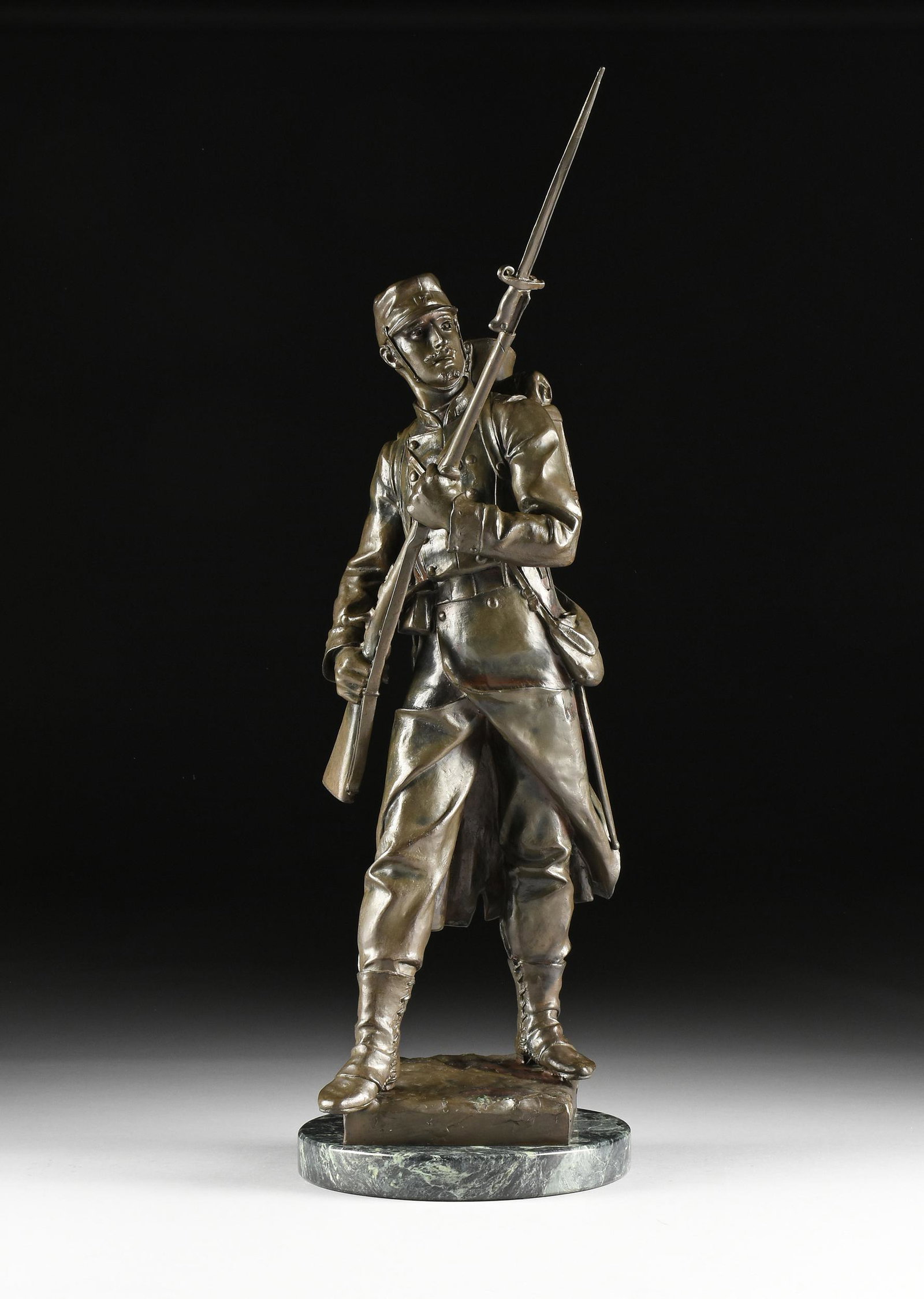 EUGÈNE MARIOTON (French 1854-1933) A BRONZE: EUGÈNE MARIOTON (French 1854-1933) A BRONZE FIGURAL SCULPTURE, "French Line Infantry Soldier," cast with a nicely detailed alert expression and striding with bayonet mounted rifle in a ready posi