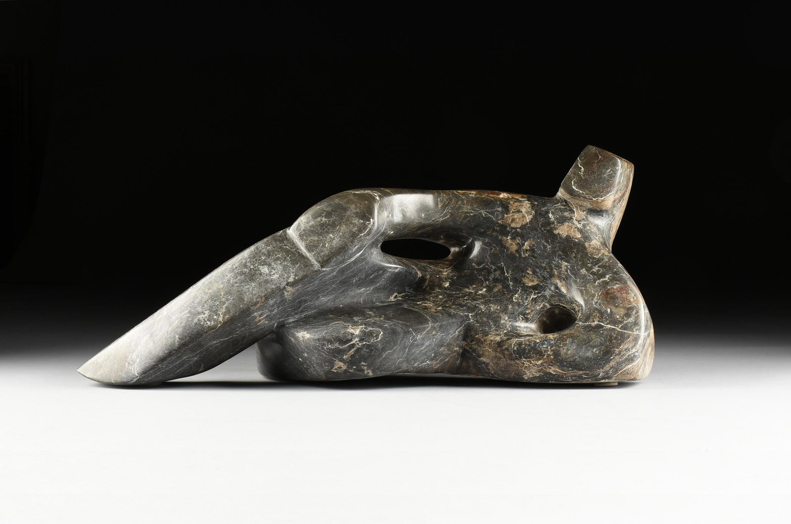 MARSHALL CUNNINGHAM (American/Texas 20th/21st Century): MARSHALL CUNNINGHAM (American/Texas 20th/21st Century) A SCULPTURE, "Figure Reclining," SIGNED, JUNE 18, 1993, carved and polished grey and brownstone, signed at base, "M.W.Cunningham," and engraved i