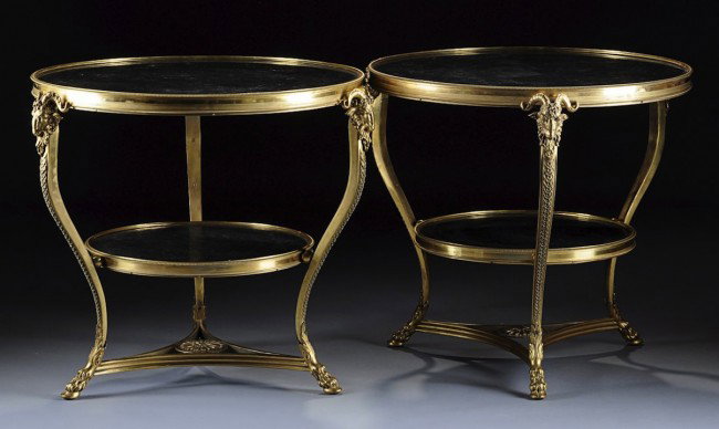 A PAIR OF FRENCH NEOCLASSICAL STYLE GILT BRONZE GR: A PAIR OF FRENCH NEOCLASSICAL STYLE GILT BRONZE GRAND GUÉRIDONS, EARLY 20TH CENTURY, each circular black fossil marble top within a reeded border above a flat burnished and stippled frieze with rope 